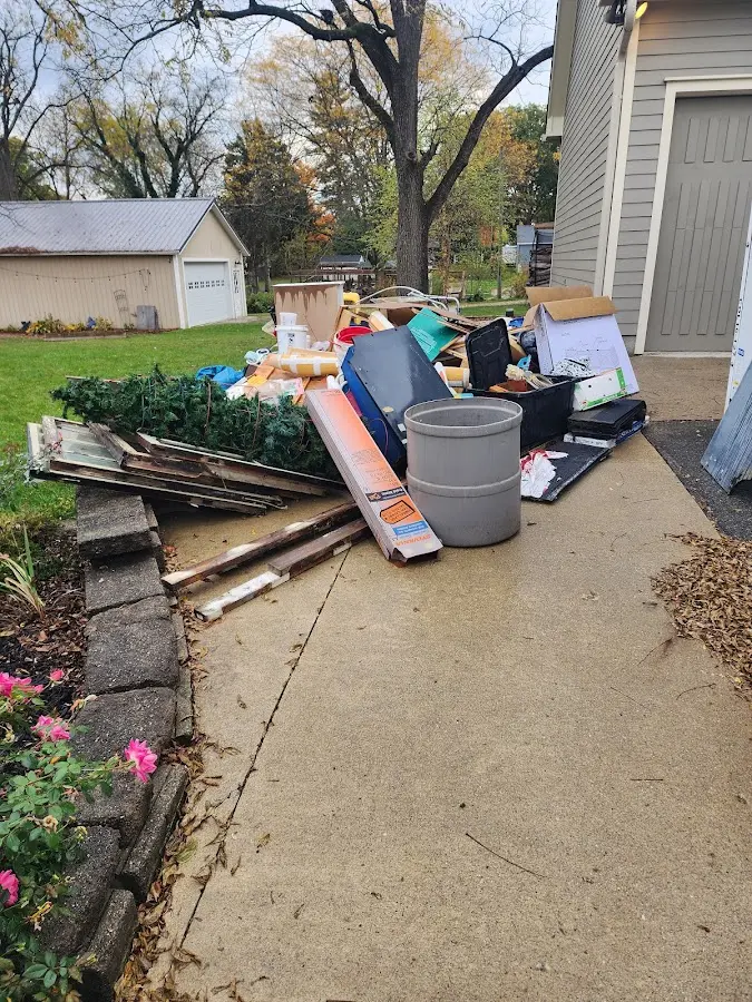 Dumpster being loaded with debris for 3 Yard Dumpster Rental in Sheldon